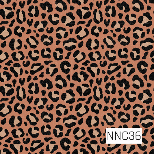 A bold leopard print featuring textured black spots with warm tan centers scattered across a rich terracotta background. The hand-painted, slightly distressed texture gives the classic animal print a fun, modern feel.
