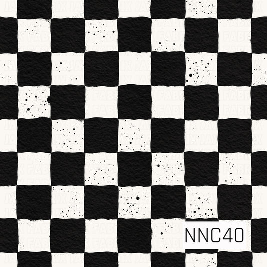 A bold black-and-white checkerboard pattern featuring slightly imperfect, hand-painted squares with a textured finish. Scattered black ink splatters add a fun distressed, artistic touch throughout the design.
