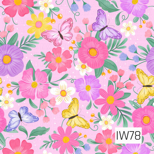 A bright and whimsical floral pattern featuring an abundance of oversized pink, lavender, yellow, and white blossoms surrounded by lush green leaves, delicate buds, and curling vines. Beautiful butterflies in shades of pink, purple, blue, and golden yellow flutter throughout the design. Set against a soft pastel pink background with tiny scattered white dots, this playful print captures the cheerful beauty of a blooming spring garden.
