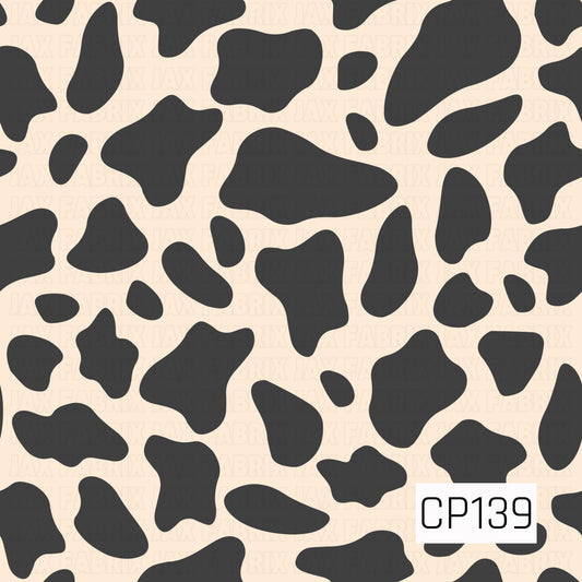 A classic cow print featuring bold black organic spots on a warm cream background. This timeless two-tone design offers a clean western-inspired look that pairs effortlessly with a wide variety of prints and solids.
