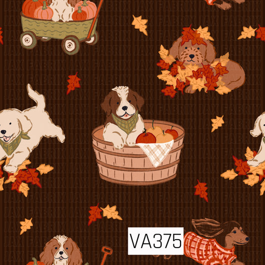 A playful fall print featuring adorable dogs enjoying all the best parts of autumn. Pups play in piles of colorful leaves, peek out from baskets filled with pumpkins, and ride along in a pumpkin-filled wagon. Scattered orange and golden leaves add to the cozy seasonal feel, all set against a rich dark brown subtly striped background.
