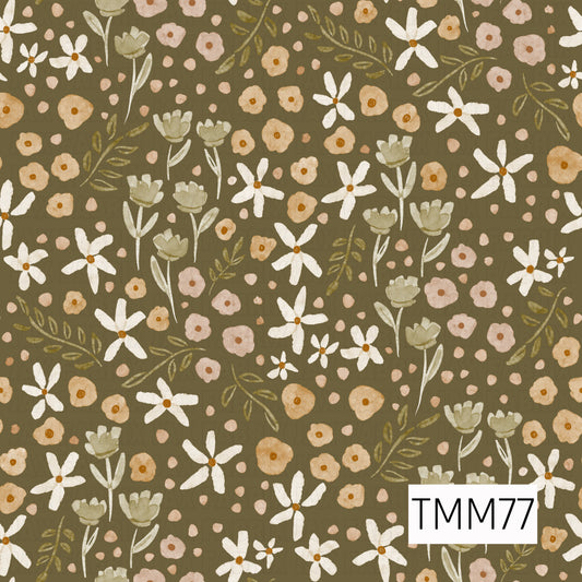 A soft watercolor floral pattern featuring creamy white daisies, muted sage green blooms, warm golden mustard flowers, and dusty blush accents. Delicate olive leafy sprigs and scattered petals are layered across an earthy olive-brown background, giving the design a cozy, vintage botanical feel.
