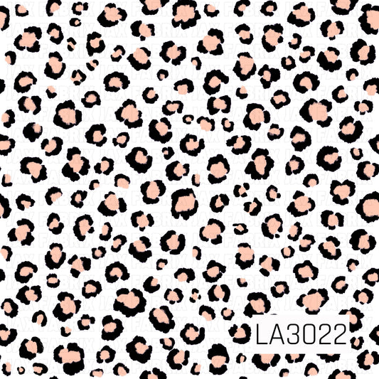 A white background covered in playful black leopard spots with soft peach centers for a cute, modern neutral look.
