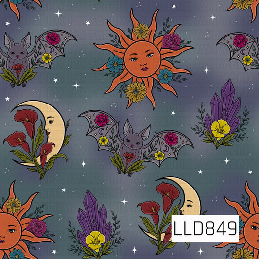 A seamless celestial pattern featuring floral suns, crescent moons with faces, bats with floral wings, purple crystals, blooming flowers, and scattered stars on a dark gray background.
