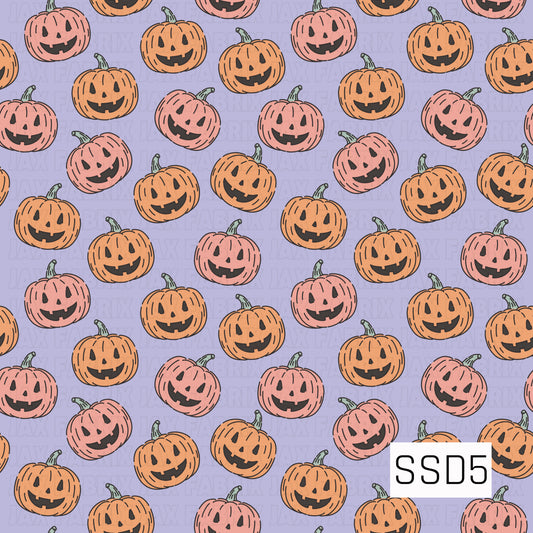 A playful Halloween pattern featuring smiling jack-o’-lanterns in soft orange and coral pink with muted green stems. The pumpkins are scattered across a pale lavender background for a cute, whimsical spooky-season look.
