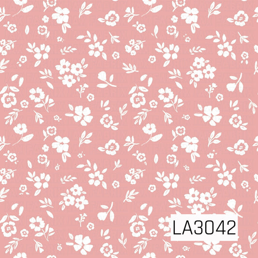 A sweet vintage floral featuring creamy white blossoms, tiny buds, and leafy sprigs scattered across a soft rosy pink background. The hand-painted texture gives it a delicate, cheerful cottage-inspired feel.
