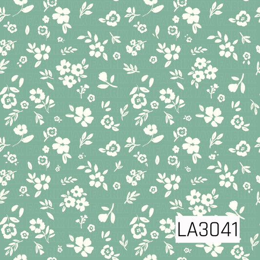 A delicate vintage floral featuring creamy white blossoms, tiny buds, and leafy sprigs scattered across a soft sage green background. The simple hand-painted texture gives it a fresh, sweet cottage-inspired feel.
