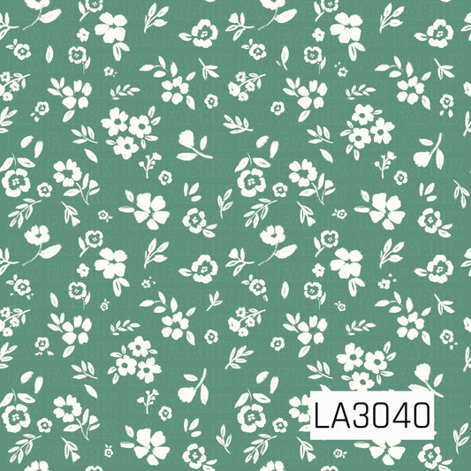A sweet vintage-inspired floral with creamy white blossoms and leafy sprigs scattered across a soft meadow green background. The simple hand-painted texture gives it a fresh, charming cottage feel.
