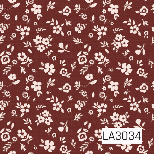 A charming vintage floral featuring delicate cream blossoms and leafy sprigs scattered across a rich raisin-brown background. The hand-painted texture and simple two-tone palette give it a warm, timeless cottage feel.
