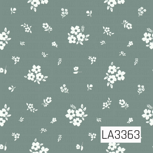 A delicate floral pattern featuring scattered ivory flower clusters, tiny blossoms, and leafy sprigs on a soft, muted sage green background. The dainty, hand-painted details give this design a sweet, vintage-inspired feel.