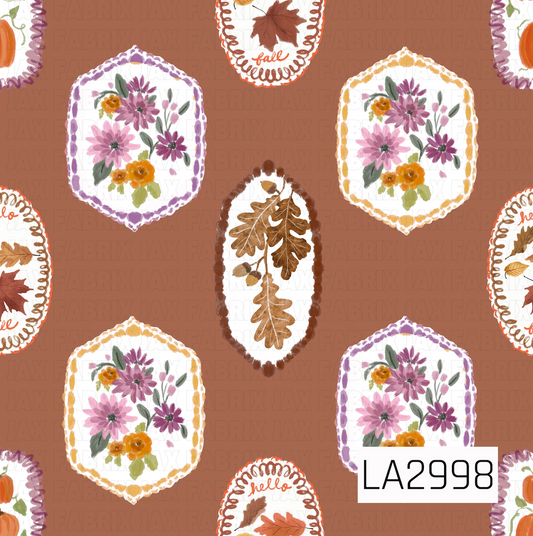 A whimsical fall panel featuring hand-painted floral frames, oak leaves, pumpkins, and autumn leaf accents on a warm cinnamon brown background. Soft watercolor florals in shades of mauve, lavender, golden yellow, and orange are paired with rustic autumn botanicals, creating a cozy vintage-inspired design perfect for seasonal sewing and crafting projects.
