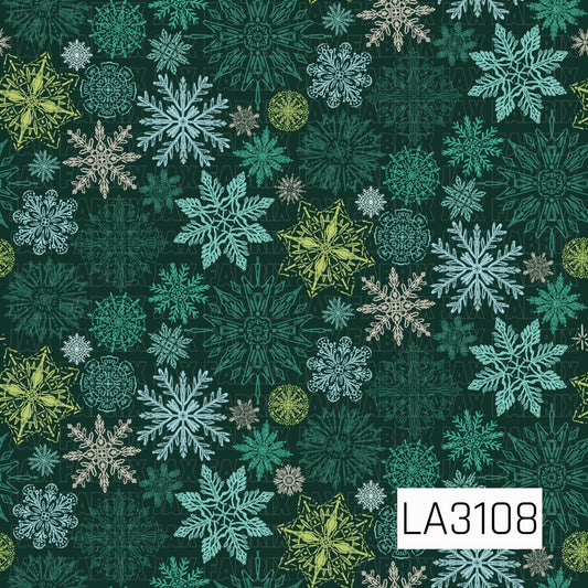 A rich winter snowflake pattern featuring an assortment of intricate, hand-drawn snowflakes in teal, icy blue, cream, lime green, and deep green against a dark forest green background. The varied colors, shapes, and sizes create a bold, layered winter look.

