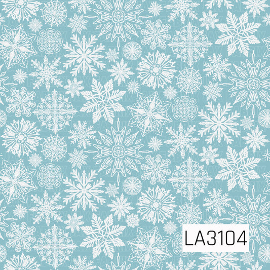 A delicate winter snowflake pattern featuring an assortment of intricate white snowflakes scattered across a soft icy blue background. The mix of large statement snowflakes and smaller detailed accents creates a light, frosty winter feel.
