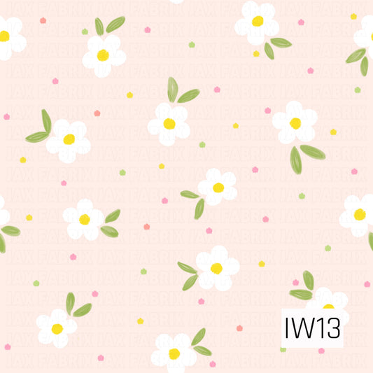 A sweet and cheerful floral pattern featuring scattered white five-petal daisies with bright sunny yellow centers and soft green leaves. Tiny confetti-like dots in shades of pink, coral, yellow, and lime green are sprinkled throughout a delicate blush pink background. The subtle hand-painted textures and whimsical arrangement create a fresh, playful design perfect for spring and summer.