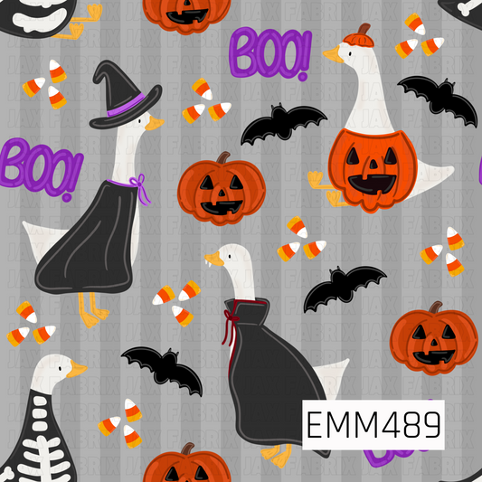 A playful Halloween goose print featuring costumed geese dressed as a witch, vampire, skeleton, and jack-o’-lantern. Orange pumpkins, black flying bats, scattered candy corn, and bold purple “BOO!” accents are arranged across a light gray striped background for a cute spooky-season look.

