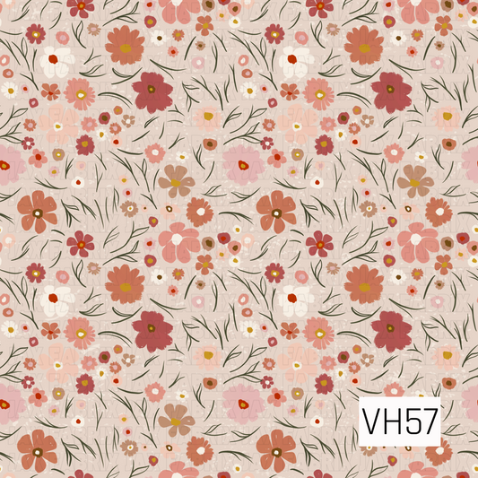 A charming vintage-inspired floral filled with scattered hand-drawn blooms in dusty rose, coral, blush pink, terracotta, cream, and warm mustard. Delicate olive-green stems and wispy leaves weave between the flowers, while subtle distressed speckles add texture to the soft neutral background. The mix of tiny blossoms and oversized blooms creates a whimsical, nostalgic meadow feel.
