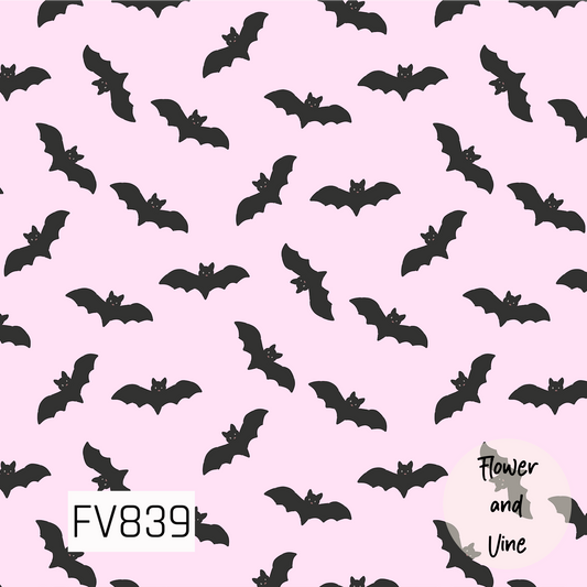 A fun Halloween print featuring playful black bats flying in different directions across a soft pastel pink background. The simple bat silhouettes and tiny facial details add a cute, slightly spooky touch, while the pink background gives this Halloween classic a sweet and girly twist.
