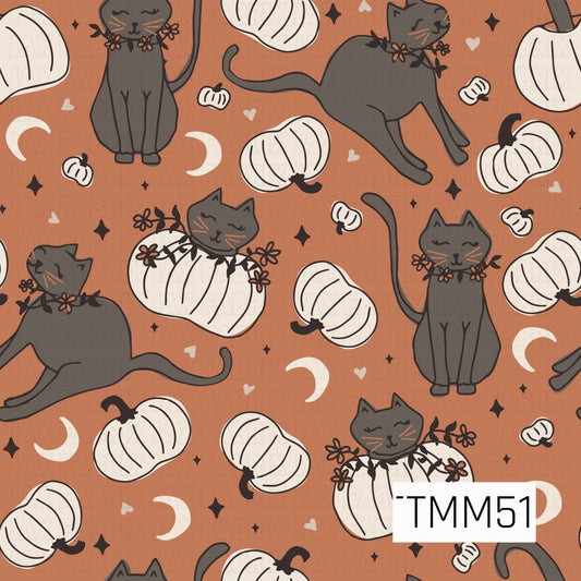 Dark gray cats with autumn floral collars lounge and play among ivory pumpkins, crescent moons, tiny hearts, and twinkling stars on a warm pumpkin orange background, creating a cozy spooky-cute Halloween pattern.
