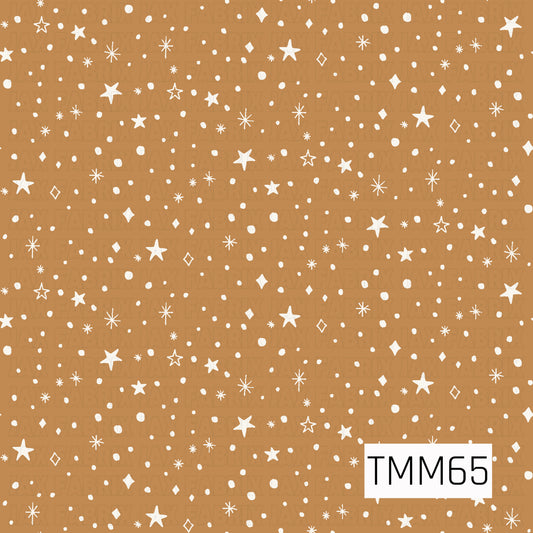 A whimsical celestial pattern featuring hand-drawn stars, sparkles, diamonds, and scattered dots in creamy white. The warm caramel brown background gives the design a cozy, earthy feel while the playful scattered elements add a touch of magic and charm.
