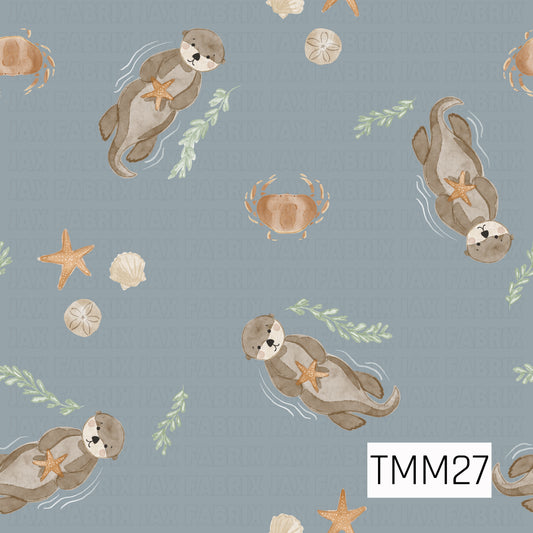 A charming watercolor-style pattern featuring playful sea otters floating across a soft harbor blue background. The otters hold sandy tan starfish and are surrounded by sage green seaweed, tan crabs, cream seashells, sand dollars, and delicate white water accents. The soothing blend of harbor blue, tan, cream, sage green, and soft brown creates a sweet, whimsical design with a calm coastal feel.
